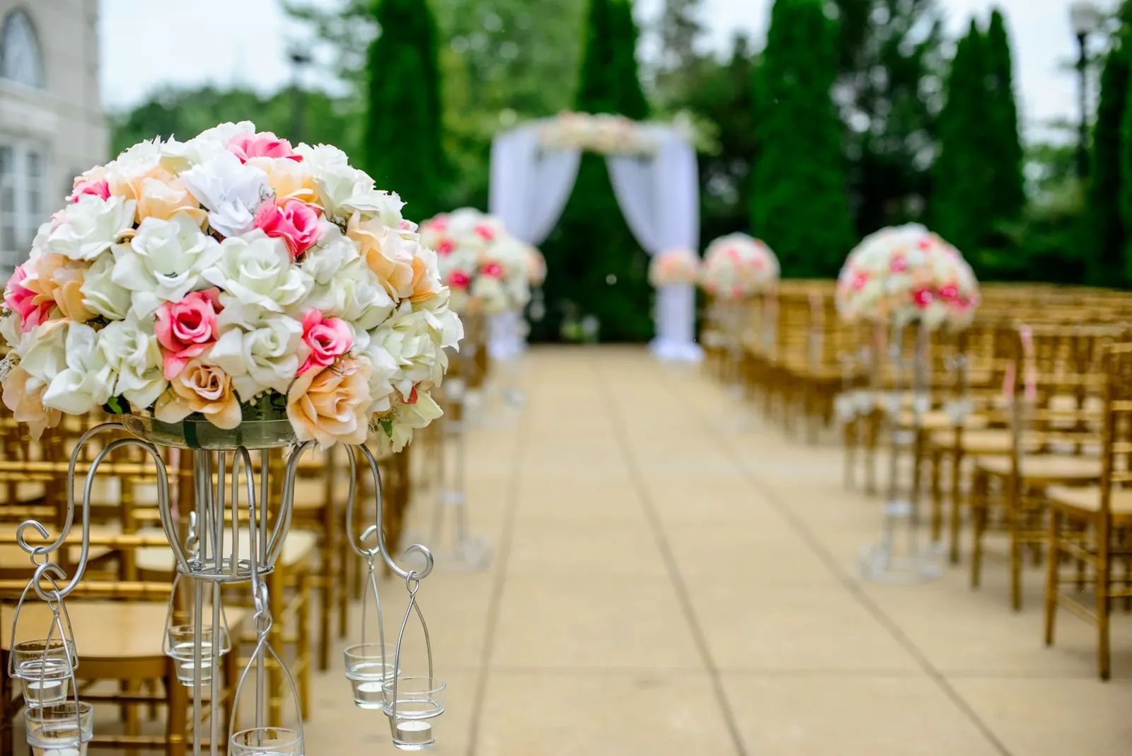 A wedding aisle lined with pink and white flowers